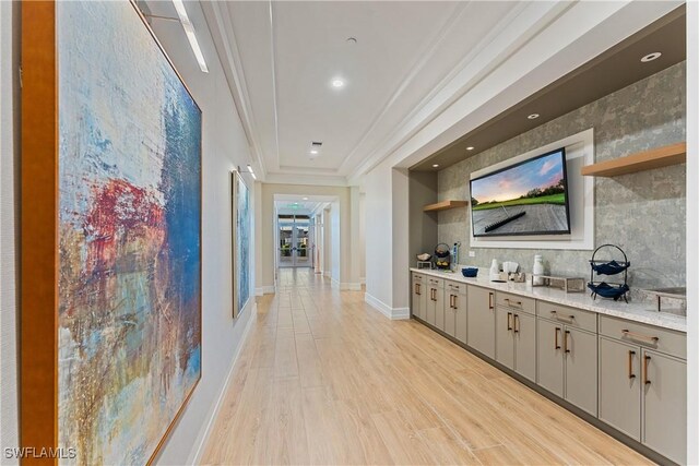 23220 Whispering Ridge Dr, Estero, FL 34135 - bar area featuring ornamental molding, light wood-style flooring, and tasteful backsplash