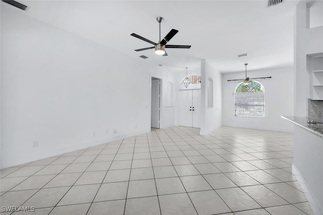 973 Summerfield Dr, Naples, FL 34120 - unfurnished living room featuring a ceiling fan and light tile patterned flooring