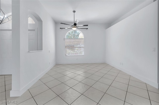 973 Summerfield Dr, Naples, FL 34120 - empty room featuring a ceiling fan, light tile patterned flooring, and arched walkways