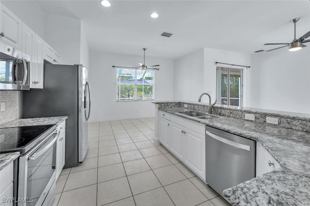 973 Summerfield Dr, Naples, FL 34120 - kitchen with a ceiling fan, appliances with stainless steel finishes, white cabinetry, light stone countertops, and recessed lighting