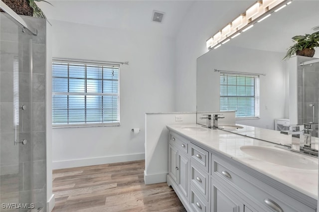973 Summerfield Dr, Naples, FL 34120 - full bathroom featuring double vanity, tiled shower, and wood finished floors