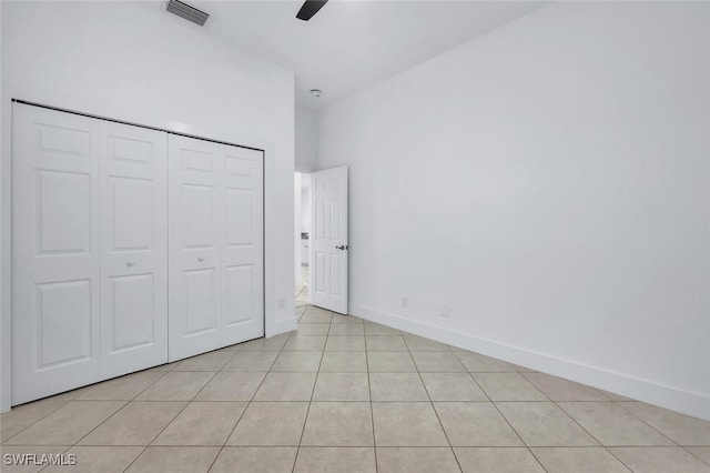973 Summerfield Dr, Naples, FL 34120 - unfurnished bedroom with light tile patterned floors, a closet, and a ceiling fan
