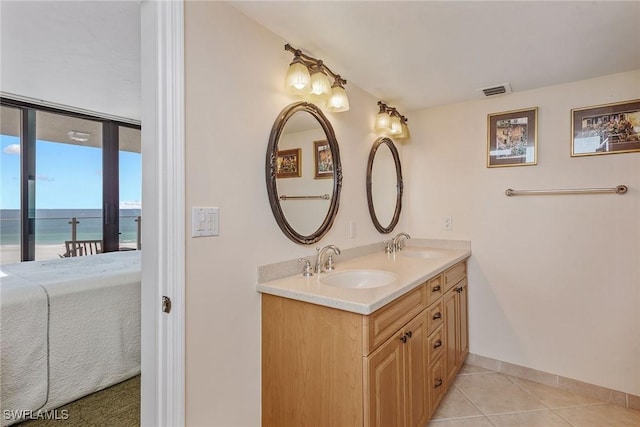 176 S Collier Blvd Unit 1107, Marco Island, FL 34145 - ensuite bathroom featuring double vanity, tile patterned flooring, and a water view