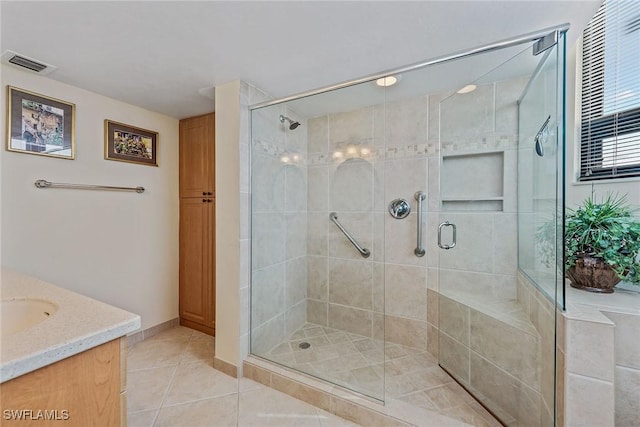 176 S Collier Blvd Unit 1107, Marco Island, FL 34145 - full bath featuring a stall shower, tile patterned floors, and vanity