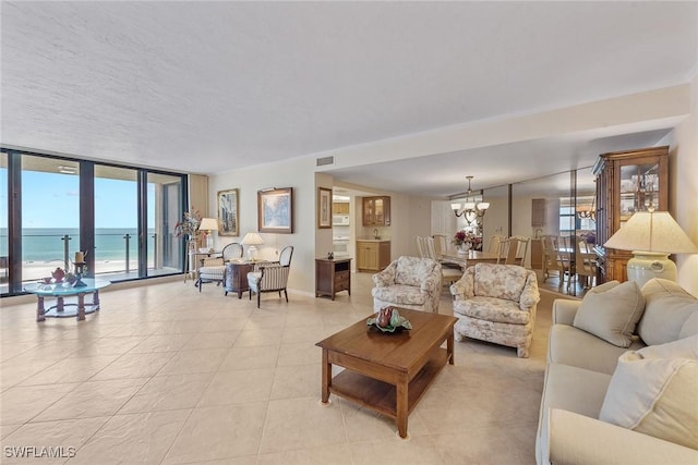 176 S Collier Blvd Unit 1107, Marco Island, FL 34145 - living area with a chandelier, expansive windows, light tile patterned floors, and healthy amount of natural light
