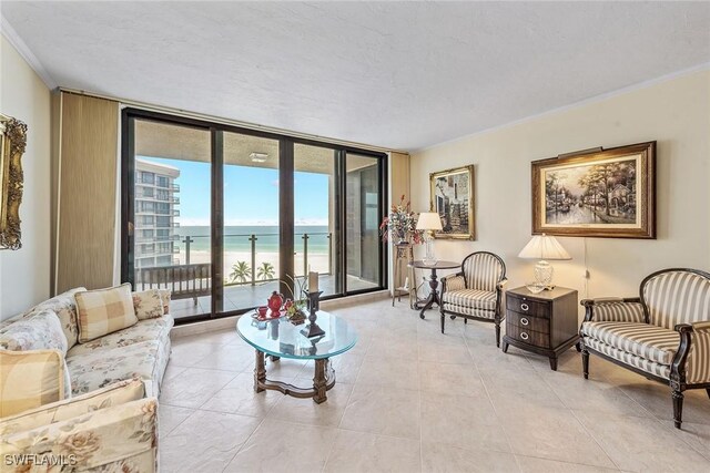 176 S Collier Blvd Unit 1107, Marco Island, FL 34145 - living room with a wall of windows, ornamental molding, a water view, a textured ceiling, and light tile patterned floors