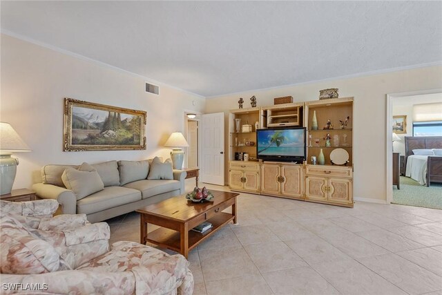 176 S Collier Blvd Unit 1107, Marco Island, FL 34145 - living room featuring crown molding and light tile patterned floors