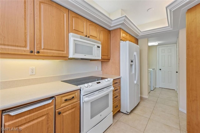 176 S Collier Blvd Unit 1107, Marco Island, FL 34145 - kitchen featuring white appliances, independent washer and dryer, light tile patterned floors, and light countertops