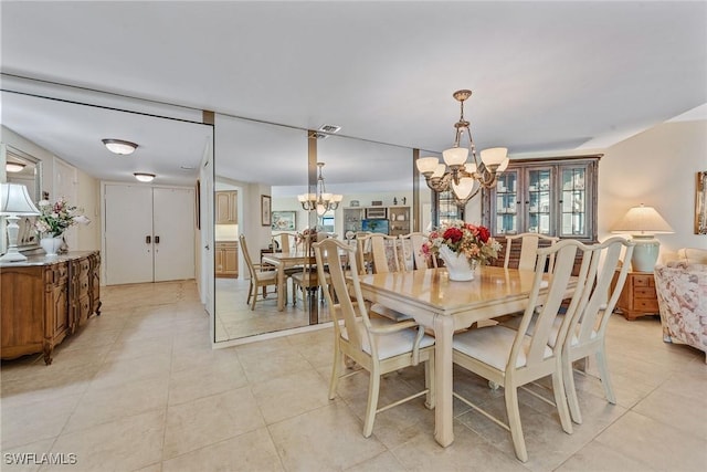 176 S Collier Blvd Unit 1107, Marco Island, FL 34145 - dining space featuring a chandelier and light tile patterned floors