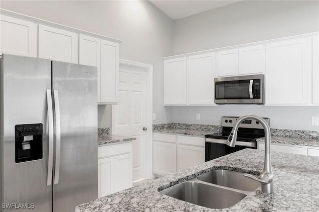 4732 NW 39th Ave, Cape Coral, FL 33993 - kitchen featuring appliances with stainless steel finishes, white cabinets, and light stone countertops