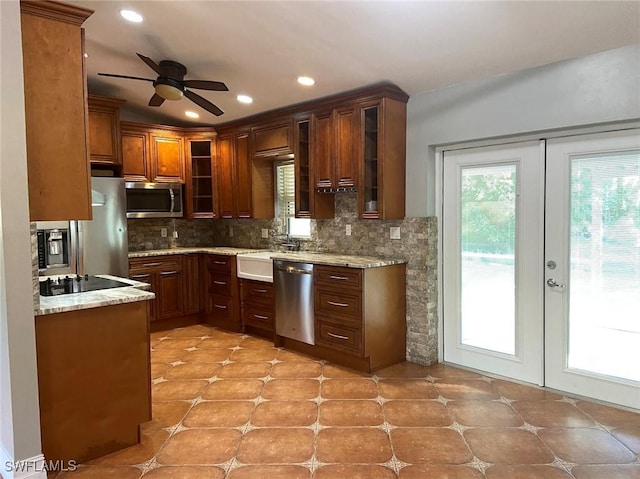 914 Avery St E, Lehigh Acres, FL 33974 - kitchen featuring stainless steel appliances, decorative backsplash, french doors, a ceiling fan, and glass insert cabinets