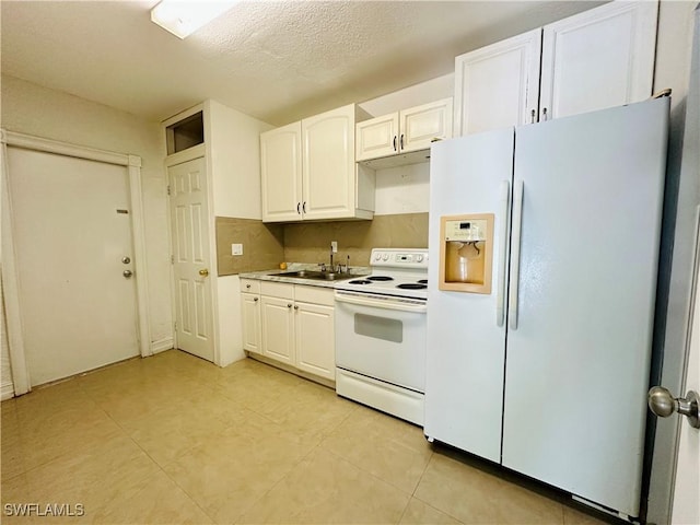 914 Avery St E, Lehigh Acres, FL 33974 - kitchen featuring white appliances, white cabinets, and light tile patterned floors