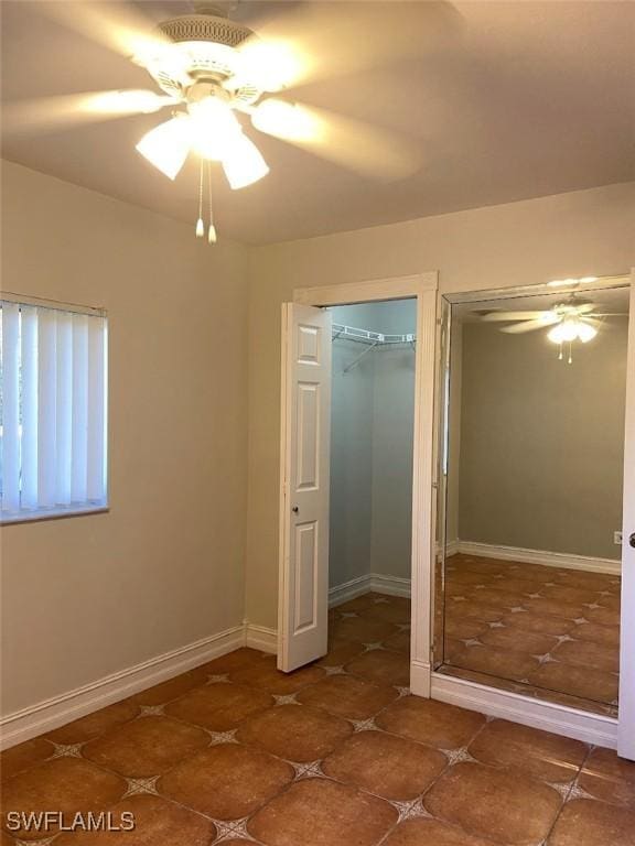 914 Avery St E, Lehigh Acres, FL 33974 - unfurnished bedroom featuring tile patterned floors, a ceiling fan, and multiple closets