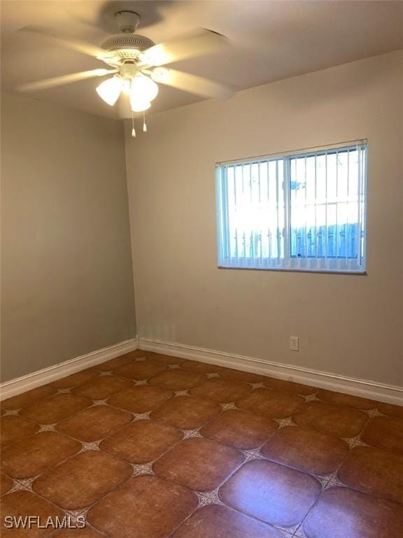914 Avery St E, Lehigh Acres, FL 33974 - tiled spare room with ceiling fan and baseboards