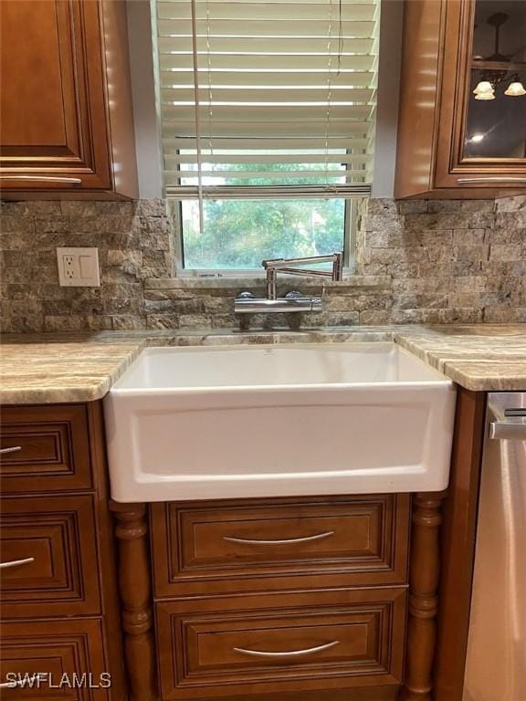 914 Avery St E, Lehigh Acres, FL 33974 - kitchen featuring tasteful backsplash, glass insert cabinets, and brown cabinetry