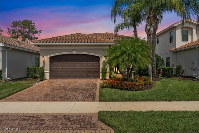 3051 Hudson Ter, Naples, FL 34119 - mediterranean / spanish-style house featuring decorative driveway, an attached garage, stucco siding, a front yard, and a tile roof
