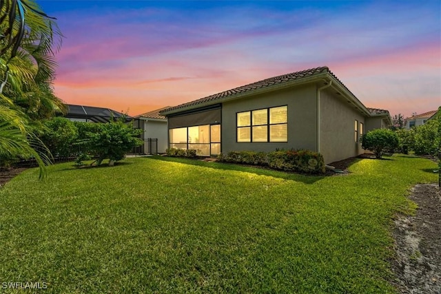 3051 Hudson Ter, Naples, FL 34119 - back of house with stucco siding, a lawn, and a tile roof
