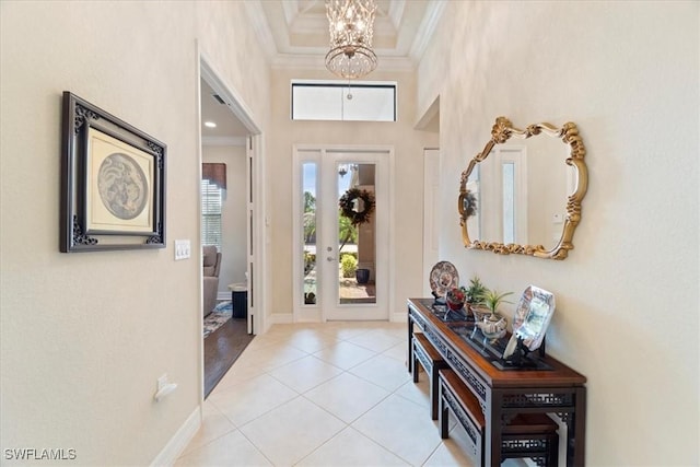 3051 Hudson Ter, Naples, FL 34119 - entryway featuring a chandelier, crown molding, light tile patterned floors, and a towering ceiling