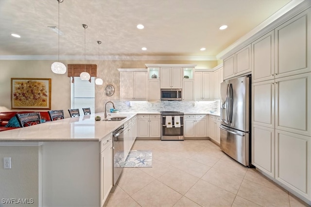 3051 Hudson Ter, Naples, FL 34119 - kitchen featuring stainless steel appliances, a peninsula, crown molding, tasteful backsplash, and light tile patterned floors