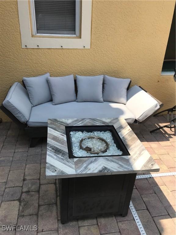 11491 Axis Deer Ln, Fort Myers, FL 33966 - view of patio / terrace with a fire pit