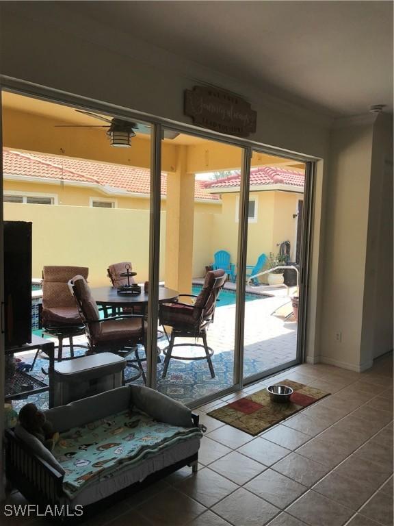 11491 Axis Deer Ln, Fort Myers, FL 33966 - doorway featuring tile patterned flooring and ornamental molding