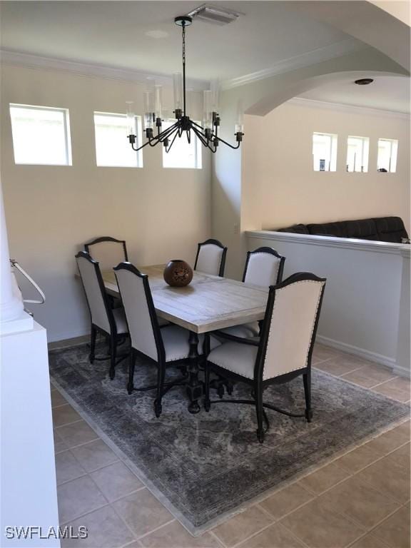 11491 Axis Deer Ln, Fort Myers, FL 33966 - dining room featuring ornamental molding, a chandelier, tile patterned floors, and arched walkways