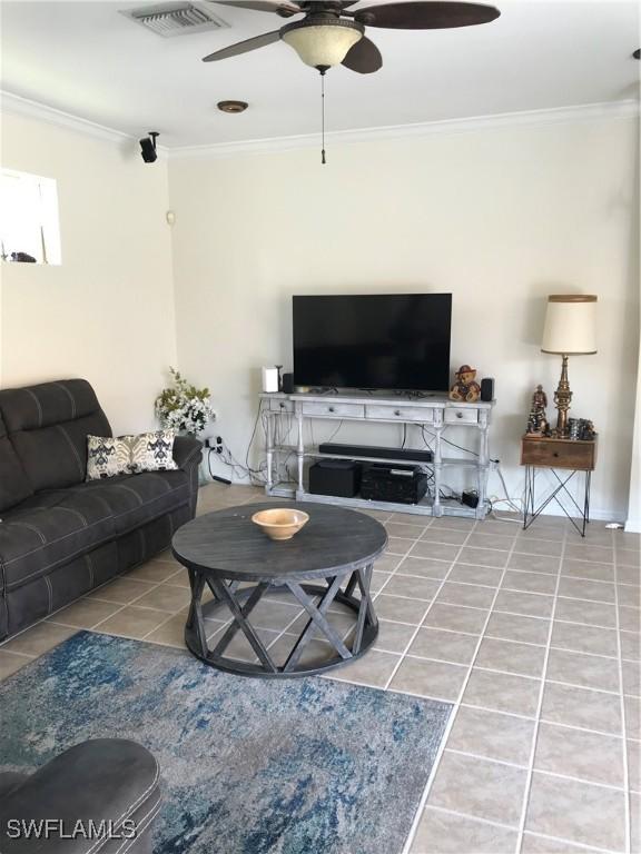 11491 Axis Deer Ln, Fort Myers, FL 33966 - tiled living room featuring ceiling fan and ornamental molding
