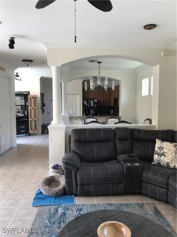 11491 Axis Deer Ln, Fort Myers, FL 33966 - living area with arched walkways, ceiling fan, light tile patterned flooring, and decorative columns