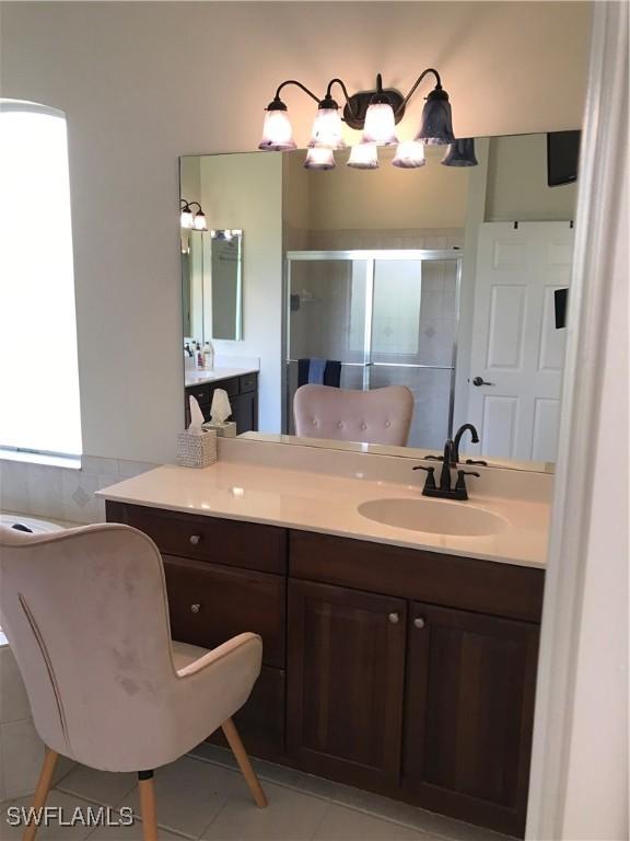 11491 Axis Deer Ln, Fort Myers, FL 33966 - bathroom featuring tile patterned flooring, a shower stall, and vanity