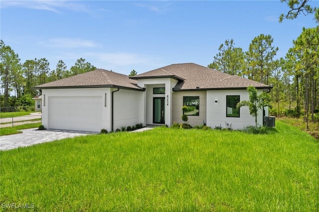 4234 27th Ave NE, Naples, FL 34120 - prairie-style house with an attached garage, a front lawn, driveway, a shingled roof, and stucco siding