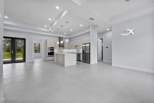 4234 27th Ave NE, Naples, FL 34120 - unfurnished living room with a raised ceiling, recessed lighting, and french doors