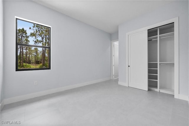 4234 27th Ave NE, Naples, FL 34120 - unfurnished bedroom featuring a closet and baseboards