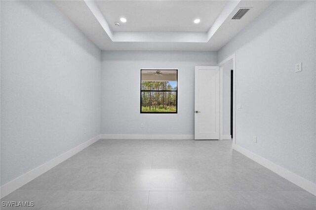 4234 27th Ave NE, Naples, FL 34120 - spare room with a tray ceiling, light tile patterned floors, and recessed lighting