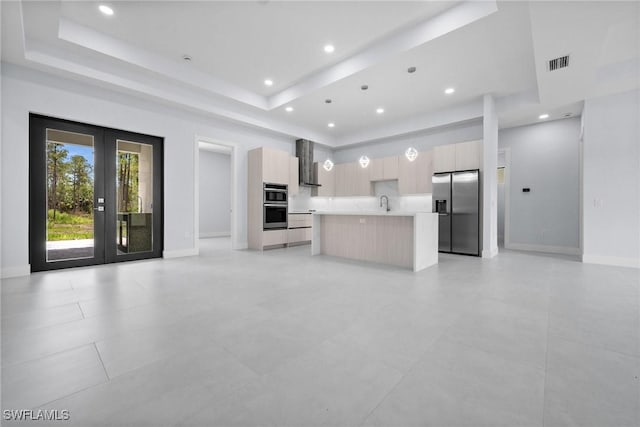 4234 27th Ave NE, Naples, FL 34120 - unfurnished living room with a tray ceiling, french doors, recessed lighting, and light tile patterned flooring