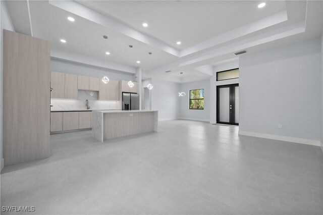 4234 27th Ave NE, Naples, FL 34120 - unfurnished living room featuring recessed lighting and a raised ceiling