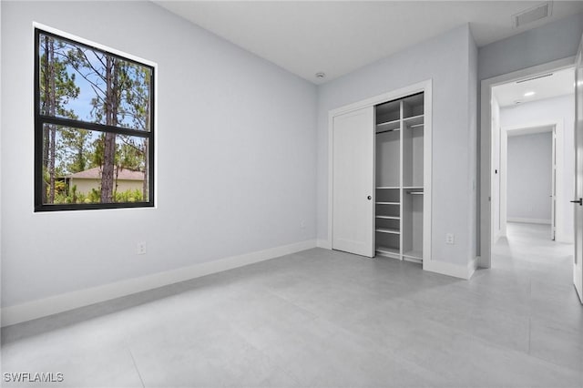 4234 27th Ave NE, Naples, FL 34120 - unfurnished bedroom featuring baseboards and a closet