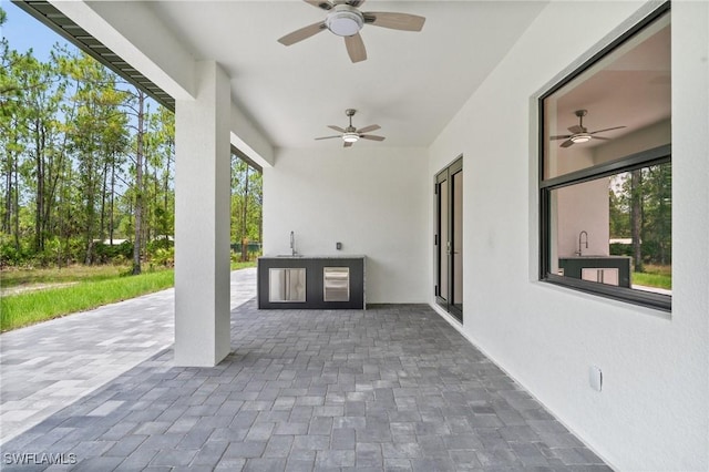 4234 27th Ave NE, Naples, FL 34120 - view of patio with ceiling fan and exterior kitchen