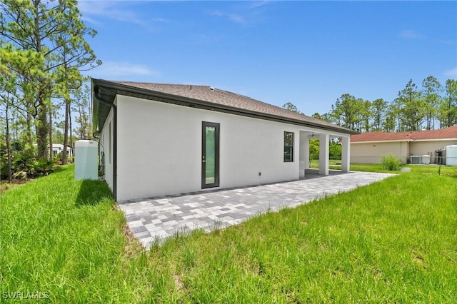 4234 27th Ave NE, Naples, FL 34120 - rear view of house with stucco siding and a patio