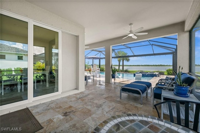 42243 Edgewater Dr, Punta Gorda, FL 33982 - view of patio / terrace with an outdoor hot tub, a ceiling fan, a water view, an outdoor pool, and glass enclosure