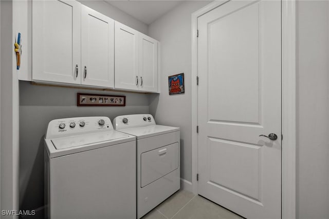 42243 Edgewater Dr, Punta Gorda, FL 33982 - laundry area featuring independent washer and dryer, cabinet space, and light tile patterned floors