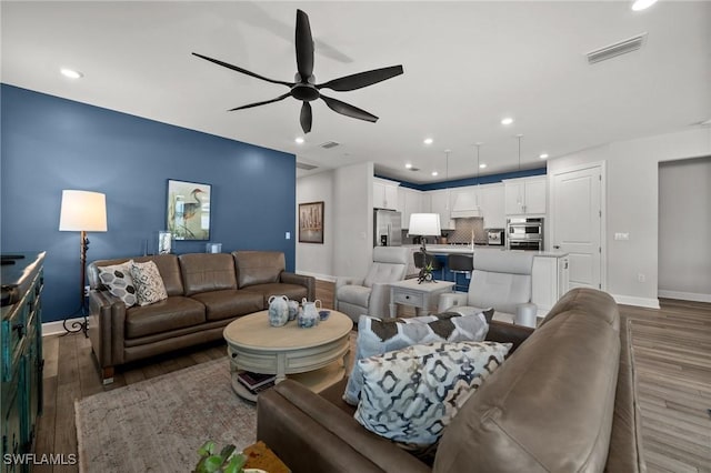42243 Edgewater Dr, Punta Gorda, FL 33982 - living area with wood finished floors, ceiling fan, and recessed lighting