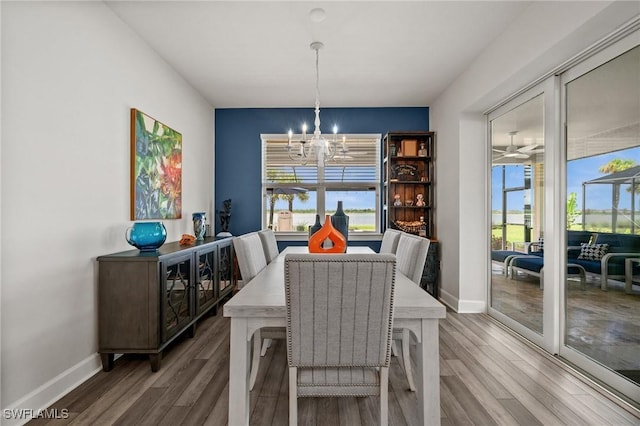 42243 Edgewater Dr, Punta Gorda, FL 33982 - dining room featuring a chandelier and wood finished floors