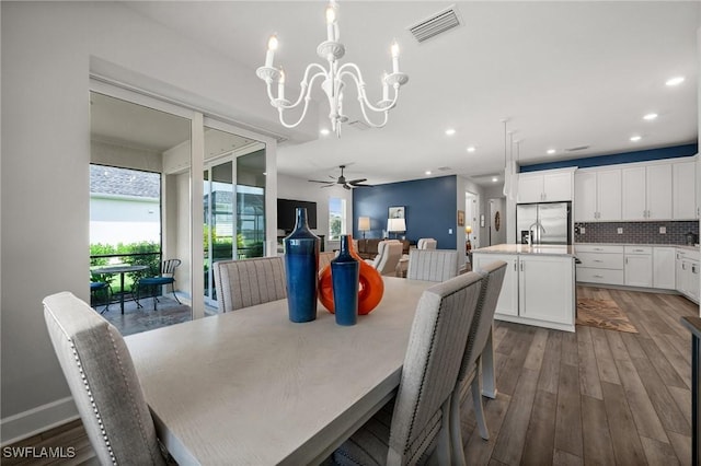 42243 Edgewater Dr, Punta Gorda, FL 33982 - dining area with a chandelier, wood finished floors, recessed lighting, and ceiling fan