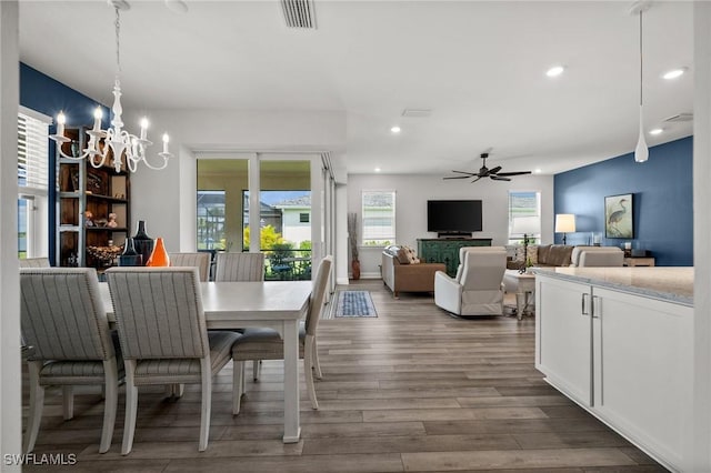 42243 Edgewater Dr, Punta Gorda, FL 33982 - dining area featuring a chandelier, wood finished floors, ceiling fan, and recessed lighting