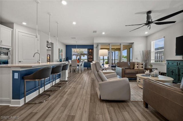 42243 Edgewater Dr, Punta Gorda, FL 33982 - living area with a ceiling fan, wood finished floors, recessed lighting, and a chandelier