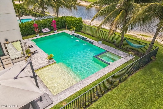 4692 Kensington Cir, Naples, FL 34119 - view of pool featuring a fenced backyard, a pool with connected hot tub, a water view, and a patio