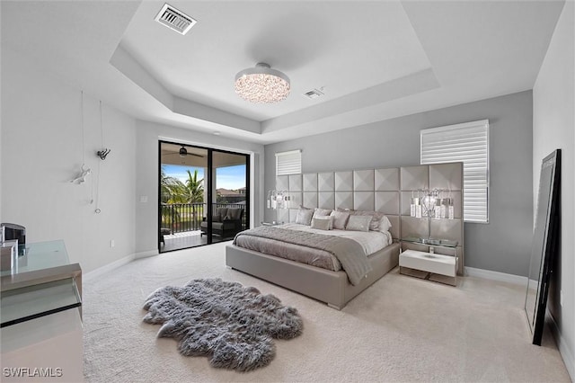 4692 Kensington Cir, Naples, FL 34119 - bedroom with access to outside, carpet floors, a raised ceiling, and a chandelier