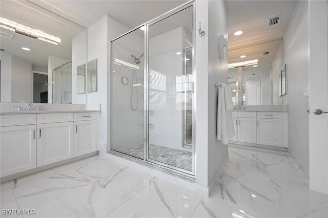 4692 Kensington Cir, Naples, FL 34119 - bathroom with marble look tiles, a stall shower, two vanities, and recessed lighting