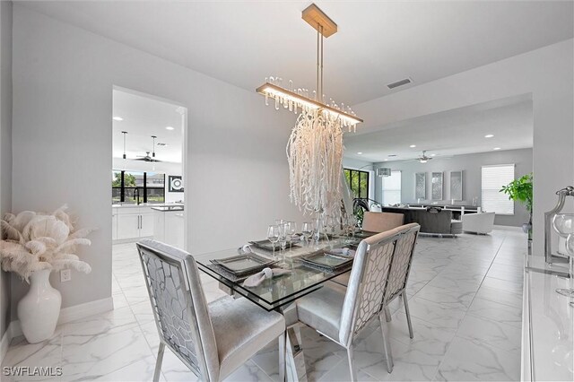 4692 Kensington Cir, Naples, FL 34119 - dining area with light marble finish floors, ceiling fan, recessed lighting, and a chandelier
