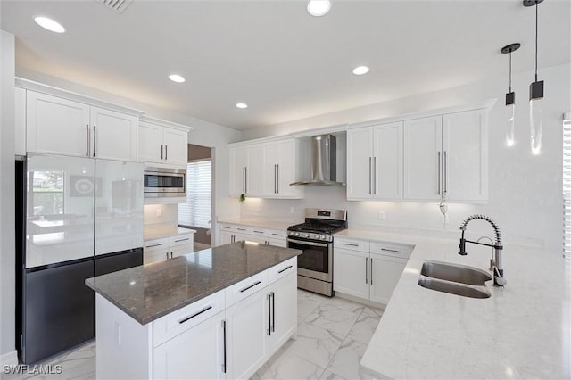 4692 Kensington Cir, Naples, FL 34119 - kitchen featuring appliances with stainless steel finishes, wall chimney exhaust hood, light marble finish flooring, healthy amount of natural light, and recessed lighting
